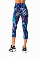 Multicolored capri leggings worn by a person on a white background